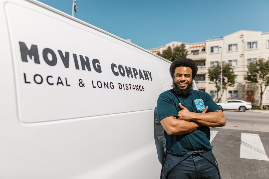 Commercial moving company in Dubai open now: A moving professional standing outside van