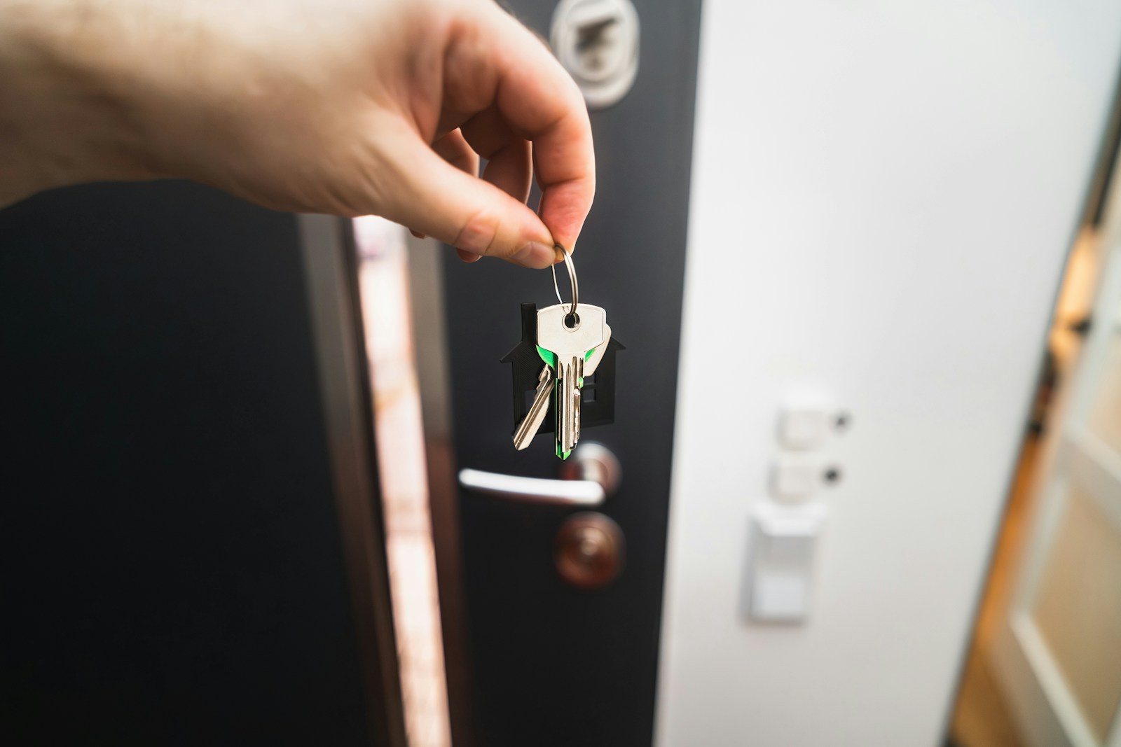 International Relocation: A person is holding a key to a door