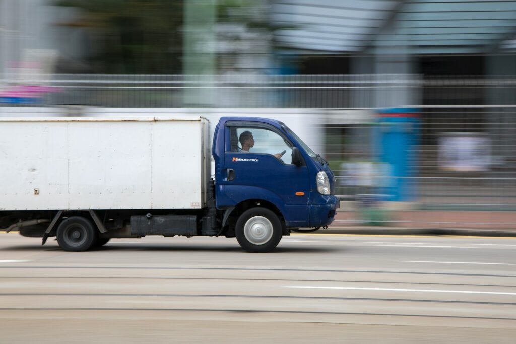 Professional Loading in Al Barsha: blue and white van on road during daytime