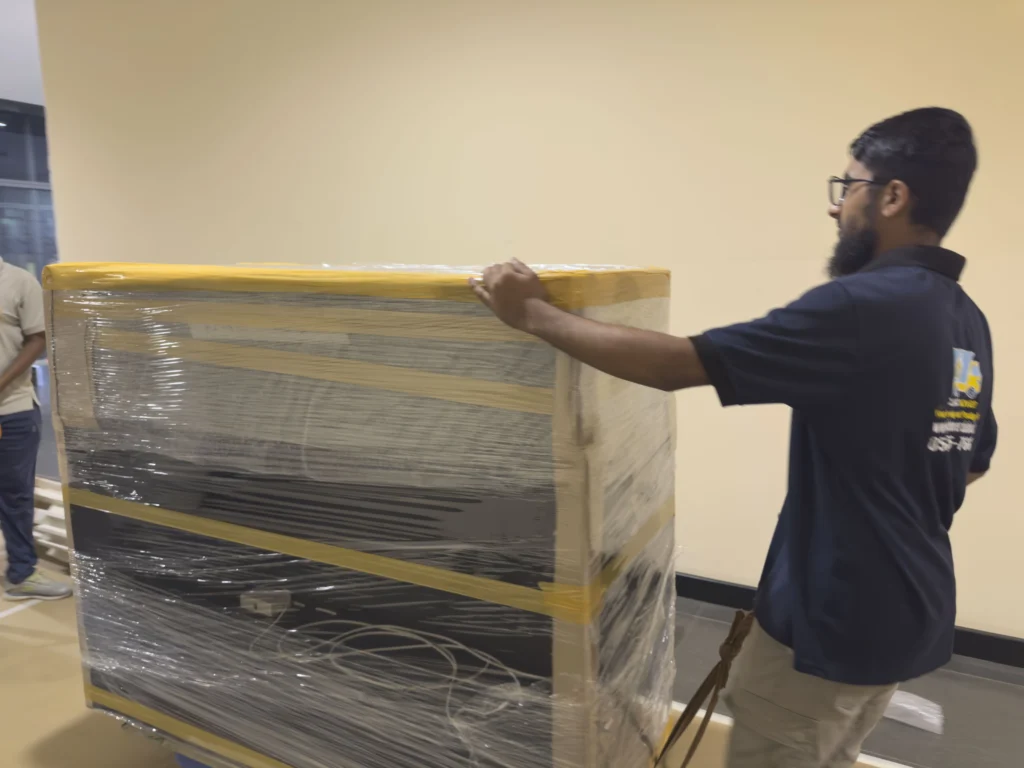 Classic Mover crew wrapping furniture for a Dubai Sports City move